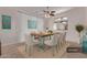 Bright dining room with a wooden table, six chairs, and lovely decor against white vertical blinds at 18155 N Sterling Dr, Surprise, AZ 85374