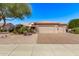 Charming single-story home featuring a three-car garage, desert landscaping and a tile roof, offering curb appeal at 18155 N Sterling Dr, Surprise, AZ 85374