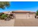 Charming single-story home featuring a three-car garage, desert landscaping and a tile roof, offering curb appeal at 18155 N Sterling Dr, Surprise, AZ 85374