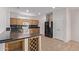 Kitchen with wood cabinets, dark countertops, tile flooring and modern appliances at 18155 N Sterling Dr, Surprise, AZ 85374