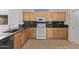 Bright kitchen with wooden cabinets, granite countertops, and modern appliances at 18155 N Sterling Dr, Surprise, AZ 85374