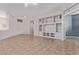 Entrance to a living room featuring a built-in entertainment center, and tile flooring at 18155 N Sterling Dr, Surprise, AZ 85374