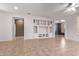 Spacious living room featuring built-in shelving and tile flooring at 18155 N Sterling Dr, Surprise, AZ 85374