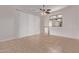 Bright living room with tile flooring, ceiling fan, and sliding glass door at 18155 N Sterling Dr, Surprise, AZ 85374