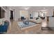 Spacious living room with a sofa, blue accent pieces, and plenty of natural light from the windows at 18155 N Sterling Dr, Surprise, AZ 85374