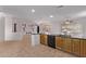 Open living space with a kitchen featuring wooden cabinets and a built-in dishwasher at 18155 N Sterling Dr, Surprise, AZ 85374