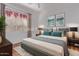 Cozy main bedroom features neutral decor, a plush rug, and a large window for natural light at 18155 N Sterling Dr, Surprise, AZ 85374