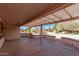 Covered outdoor patio with brick flooring and view of desert landscaping at 18155 N Sterling Dr, Surprise, AZ 85374