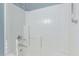 Bright white shower and tub combination features tiled walls and chrome shower head fixture at 18155 N Sterling Dr, Surprise, AZ 85374