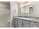 Modern bathroom featuring a single sink vanity with quartz countertops, gold hardware, and a walk-in shower at 1905 E University Dr # 162, Tempe, AZ 85288