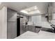 Bright kitchen with gray cabinets, stainless steel appliances, quartz countertops and a skylight at 1905 E University Dr # 162, Tempe, AZ 85288