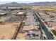 Overhead view of houses in a suburban setting near shopping area, set against mountains and featuring solar panel roofing at 19937 W Heatherbrae Dr, Litchfield Park, AZ 85340