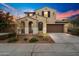 Inviting two-story home with well-maintained landscaping, tile roof, and an attached two car garage at 19937 W Heatherbrae Dr, Litchfield Park, AZ 85340