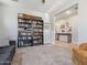 Spacious living room features tile and carpet, and a bookshelf perfect for displaying books or décor at 19937 W Heatherbrae Dr, Litchfield Park, AZ 85340