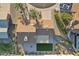 Aerial view of a home's roof, with brick patio, small patch of green turf, desert landscaping and mature palm trees at 2004 W Kristal Way, Phoenix, AZ 85027