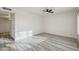 Minimalist bedroom with wood-look flooring, ceiling fan, and access to the backyard at 2004 W Kristal Way, Phoenix, AZ 85027