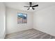 Bright bedroom featuring a ceiling fan, a window view, and wood-look flooring at 2004 W Kristal Way, Phoenix, AZ 85027