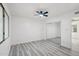 Bedroom with wood-look flooring, ceiling fan, and sliding mirrored closet doors at 2004 W Kristal Way, Phoenix, AZ 85027