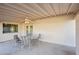 Inviting covered patio with ceiling fan, perfect for outdoor dining and relaxation with views of the lush backyard at 2004 W Kristal Way, Phoenix, AZ 85027