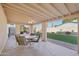 Inviting covered patio with ceiling fan, perfect for outdoor dining and relaxation with views of the lush backyard at 2004 W Kristal Way, Phoenix, AZ 85027
