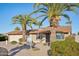 Inviting single-story house with brick accents, desert landscaping, and mature palm trees, offering curb appeal at 2004 W Kristal Way, Phoenix, AZ 85027