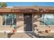 Charming brick home featuring a secure front door, decorative planters, and sunlit windows, offering a welcoming entry at 2004 W Kristal Way, Phoenix, AZ 85027