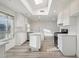 Modern kitchen features white cabinets, a skylight, stainless steel appliances, and hardwood floors at 2004 W Kristal Way, Phoenix, AZ 85027