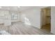 Open-concept living area with sleek floors and access to the kitchen and bathroom at 2004 W Kristal Way, Phoenix, AZ 85027