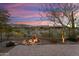 The backyard features pavers, a beautiful light feature, and a sunset view of the mountains at 20584 W Hillcrest Blvd, Buckeye, AZ 85396