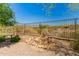 Private backyard with fence, rock garden, and desert landscape offers a serene outdoor space at 20584 W Hillcrest Blvd, Buckeye, AZ 85396