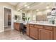 Spacious bathroom with double sink vanity, large mirror, and a separate room with a walk-in shower at 20584 W Hillcrest Blvd, Buckeye, AZ 85396