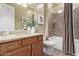 Clean bathroom with granite counters, wood cabinets, large mirror, and a shower-tub combination at 20584 W Hillcrest Blvd, Buckeye, AZ 85396