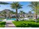 Resort-style community pool area with palm trees, lounge chairs, and mountain views at 20584 W Hillcrest Blvd, Buckeye, AZ 85396