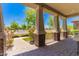 Inviting covered porch showcases brick pavers, stone columns, and views of the neighborhood at 20584 W Hillcrest Blvd, Buckeye, AZ 85396