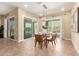 Bright dining room with a modern chandelier, tile flooring, and sliding glass doors to the backyard at 20584 W Hillcrest Blvd, Buckeye, AZ 85396