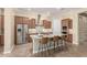 Modern kitchen features an island with bar seating, stainless steel appliances, and tile backsplash at 20584 W Hillcrest Blvd, Buckeye, AZ 85396