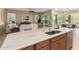 Open-concept kitchen with granite countertops, a large island, and views of the living and dining areas at 20584 W Hillcrest Blvd, Buckeye, AZ 85396