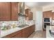 Stylish kitchen boasts granite countertops, stainless steel appliances, and ample cabinet space at 20584 W Hillcrest Blvd, Buckeye, AZ 85396
