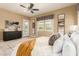 Neutral main bedroom featuring multiple windows providing natural light and access to outdoor patio at 20584 W Hillcrest Blvd, Buckeye, AZ 85396