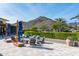 Inviting outdoor lounge area with comfortable seating, fire pit, and mountain views at 20584 W Hillcrest Blvd, Buckeye, AZ 85396