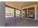 A covered patio with brick pavers and a large sliding glass door enhances outdoor living at 20584 W Hillcrest Blvd, Buckeye, AZ 85396