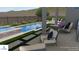 Gorgeous pool and jacuzzi with comfortable seating, a modern fire pit, and beautifully designed landscaping for serene relaxation at 20584 W Hillcrest Blvd, Buckeye, AZ 85396