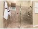Walk-in shower with glass enclosure, built-in seat and niche, and multiple shower heads at 20584 W Hillcrest Blvd, Buckeye, AZ 85396