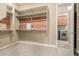 Large walk-in closet with wood shelving and an adjacent laundry room with front-load washer and dryer at 20584 W Hillcrest Blvd, Buckeye, AZ 85396