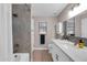 Modern bathroom with a gray tiled shower, white vanity, and updated fixtures at 21640 N 48Th St, Phoenix, AZ 85054
