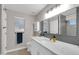 Bathroom with a walk-in shower, white vanity, and updated fixtures at 21640 N 48Th St, Phoenix, AZ 85054