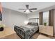 This bedroom offers a ceiling fan, wood floors and neutral walls at 21640 N 48Th St, Phoenix, AZ 85054