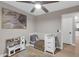 Neutral bedroom featuring a crib and a play kitchen at 21640 N 48Th St, Phoenix, AZ 85054