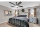 This bedroom boasts a ceiling fan, wooden floors, and ample natural light at 21640 N 48Th St, Phoenix, AZ 85054