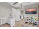 Bedroom features a changing table and closet with toys and a television at 21640 N 48Th St, Phoenix, AZ 85054